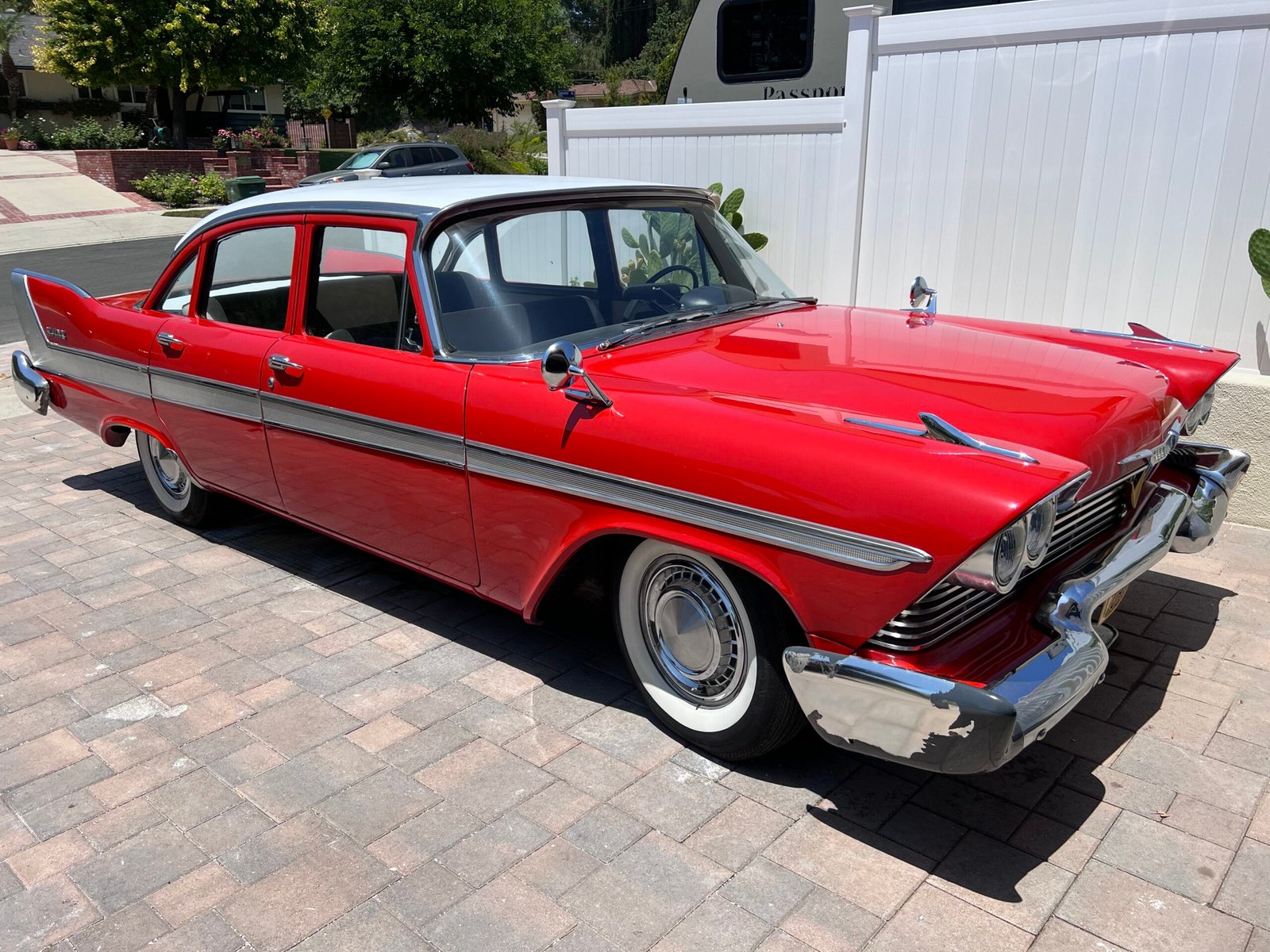 After paint correction on red car showing restored gloss and shine